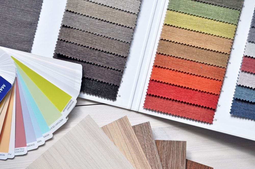 Fan deck of colour and fabric swatches laid on a table