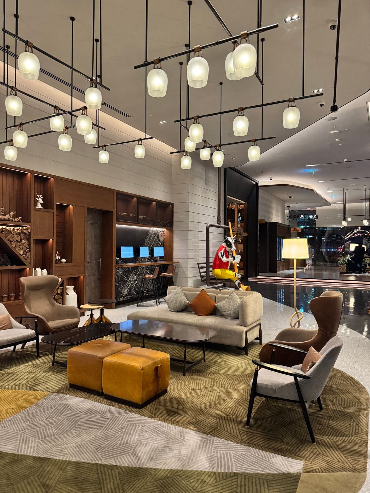 Lounge with warm pendant lighting and a wall of shelves
